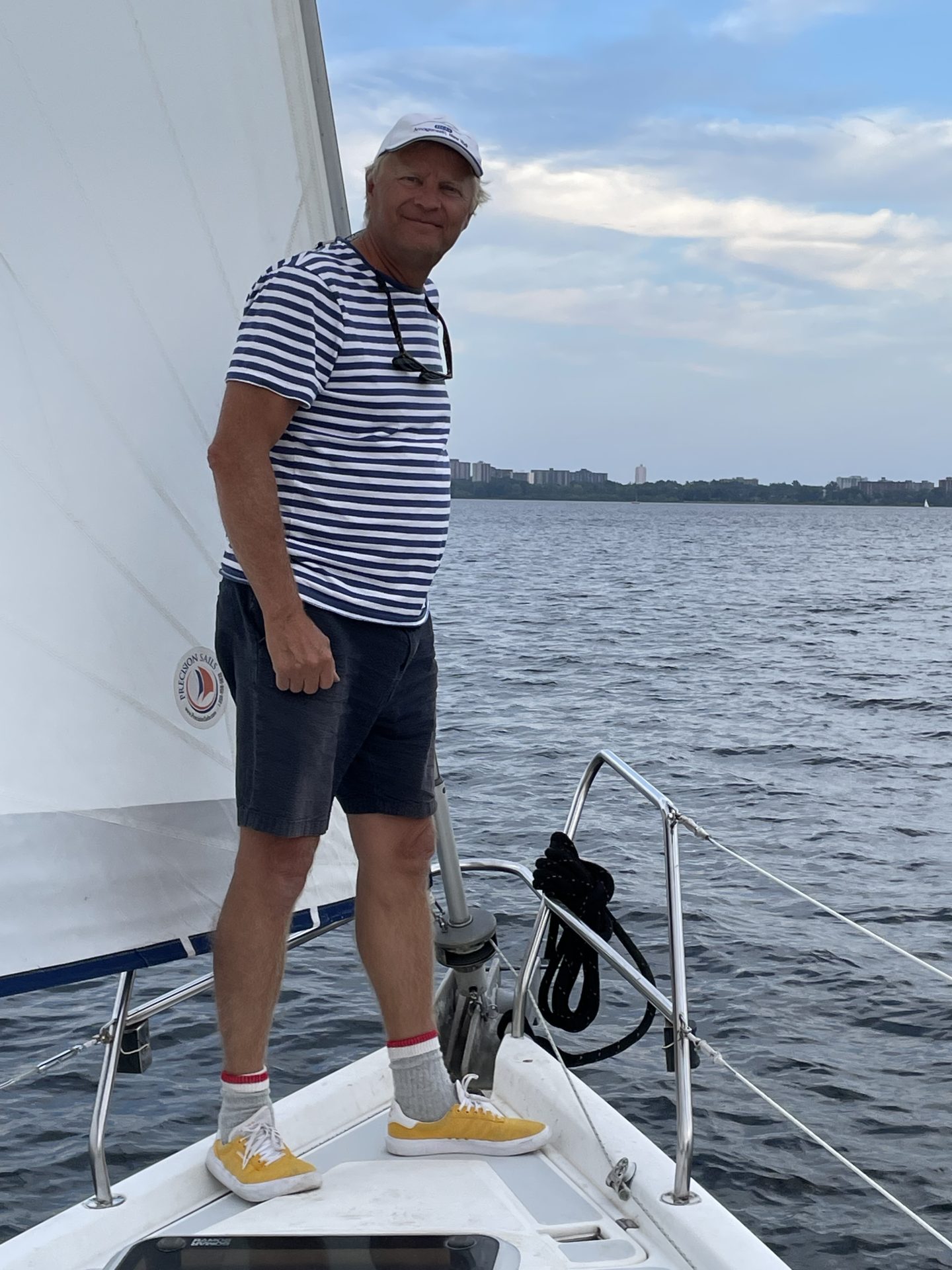 1 person standing on the bow of a sailboat