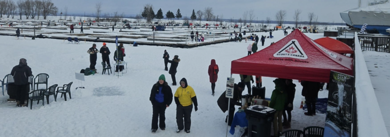 Participants and red tent on the ice with docks in the backgroundParticipants and red tent on the ice with docks in the background