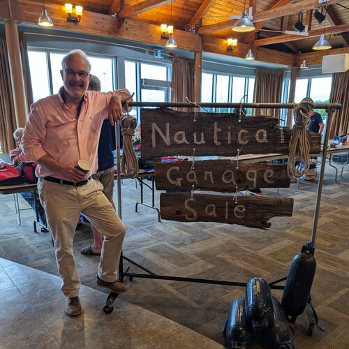 Bryan Van poses with his Nautical Garage Sale sign.
