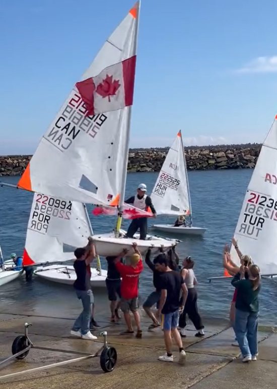 Youth hoist Carlos Charabati up in his laser 4. 