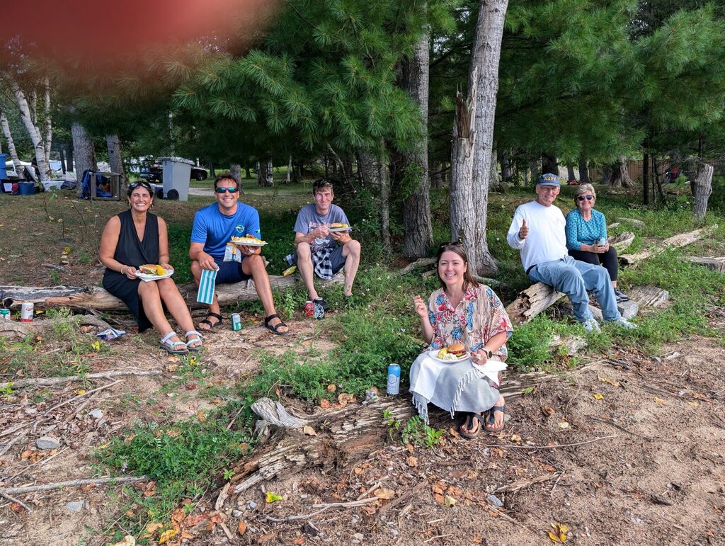 people sitting on a log