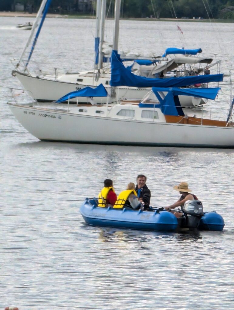 dingy in front of a sailboat