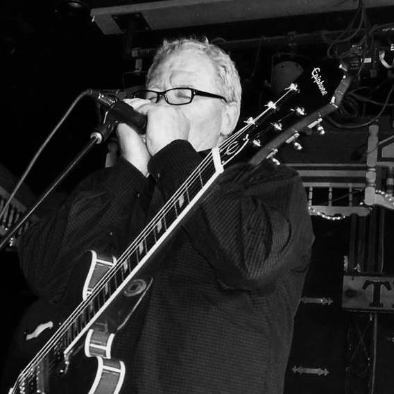 Jim Cochrane plays mouth organ and guitar